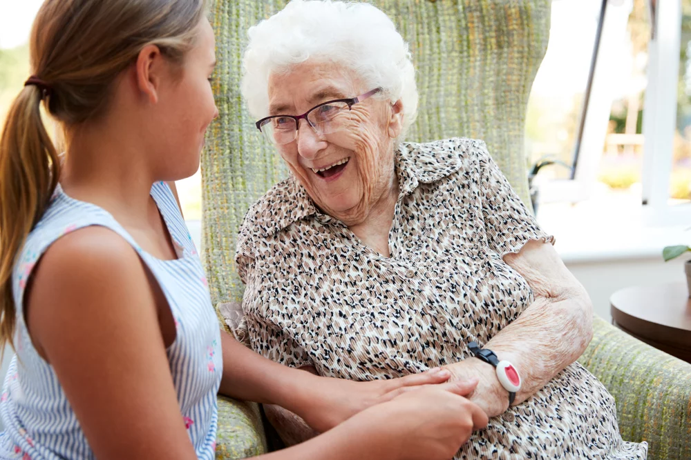 Granddaughter visiting grandmother in memory care facility